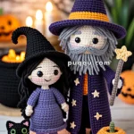 Crocheted dolls of a witch and a wizard standing on an orange mat with a black cat and two pumpkins, with a Halloween-themed background.